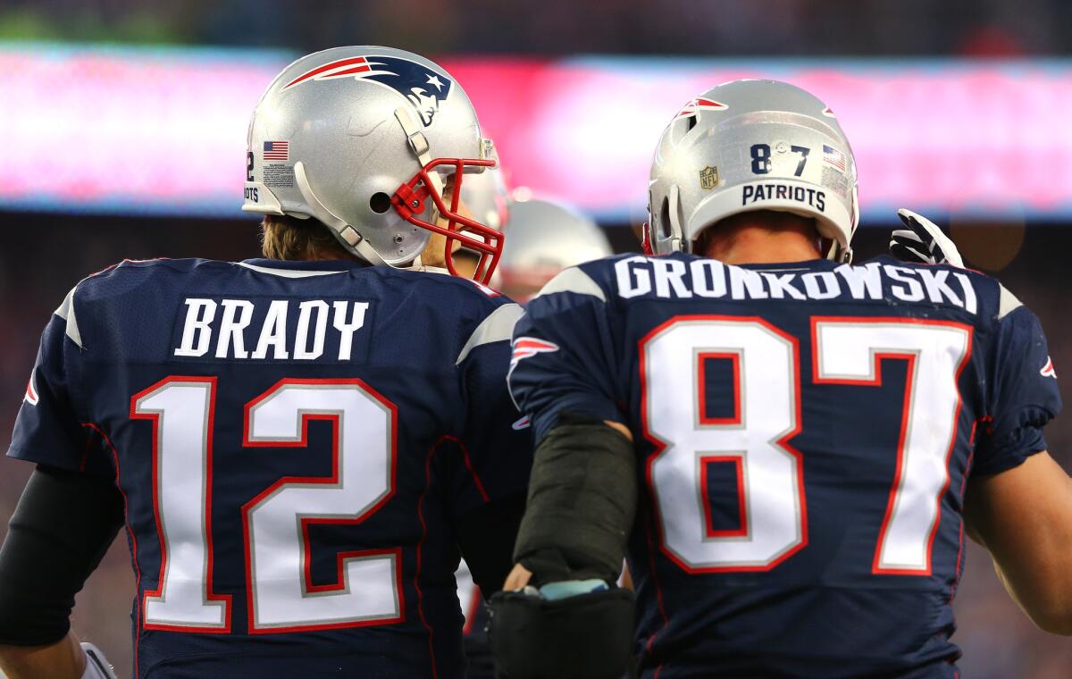 New England Patriots quarterback Tom Brady talks with tight end Rob Gronkowski after a touchdown against the Kansas City Chiefs during the divisional round of the NFL playoffs on Jan. 16.