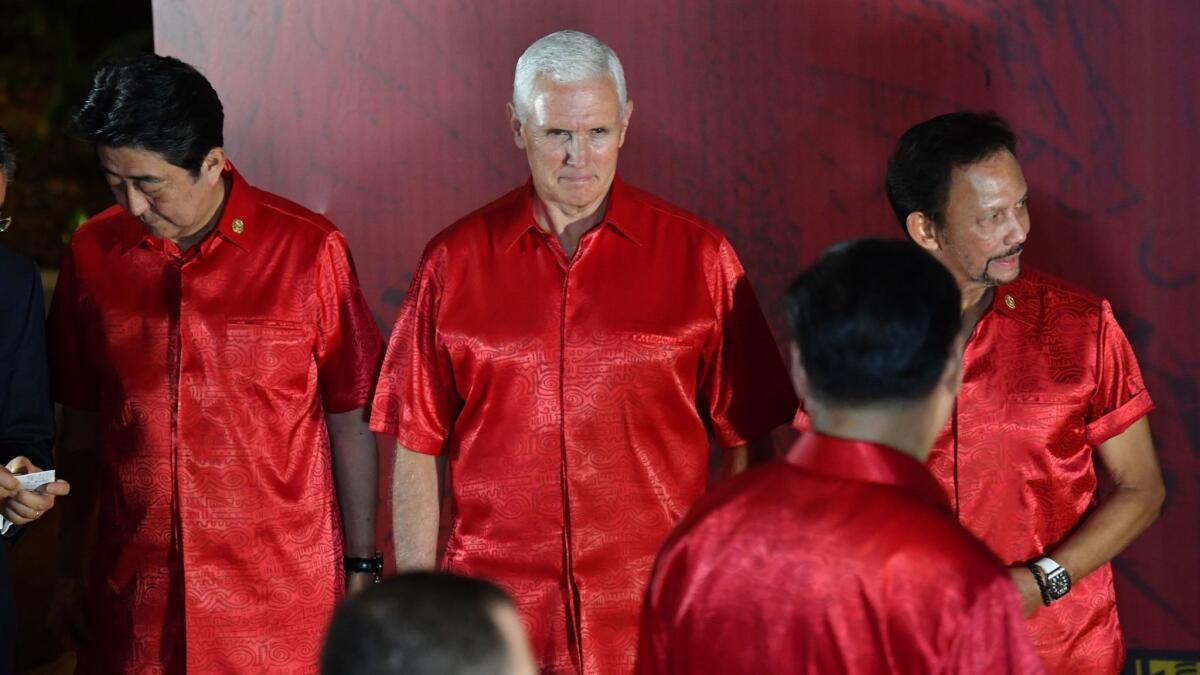 Vice President Mike Pence looks at Chinese President Xi Jinping before a photograph at the Asia-Pacific Economic Cooperation summit gala dinner in Papua New Guinea on Nov. 17.