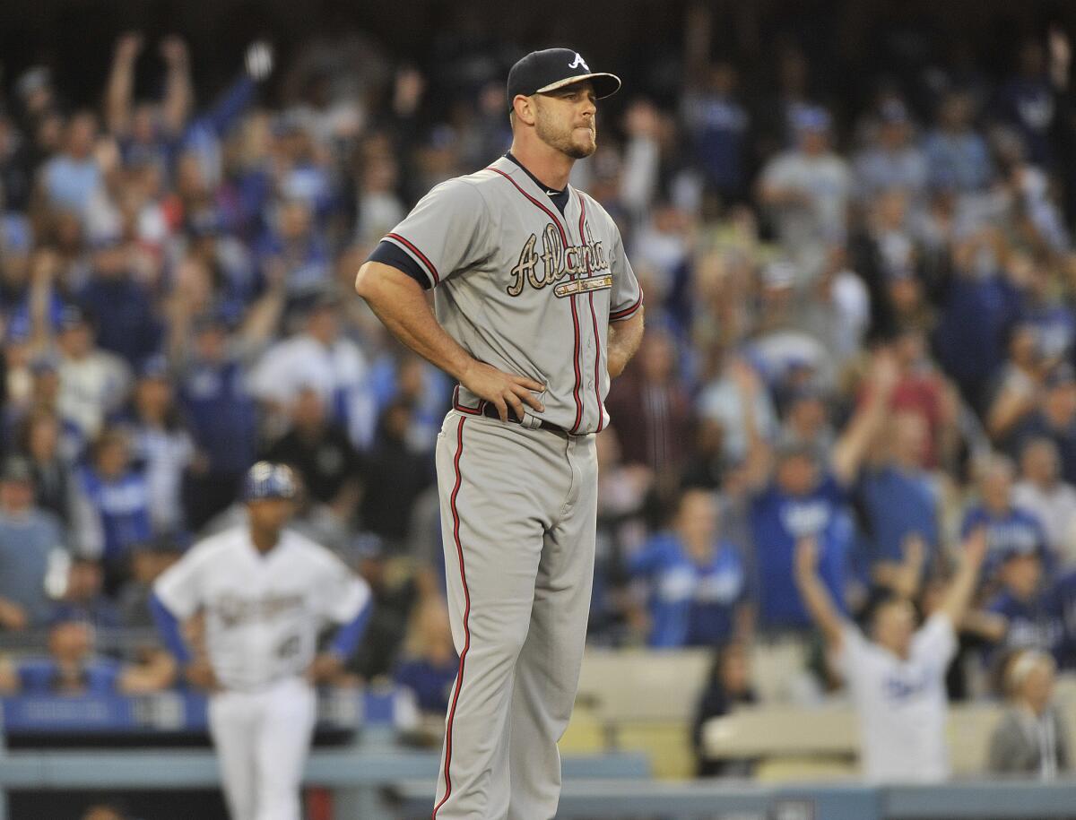 Braves relief pitcher Nick Masset reacts after giving up a home run in the eighth inning. The Dodgers bombarded Masset for three homers in the inning.