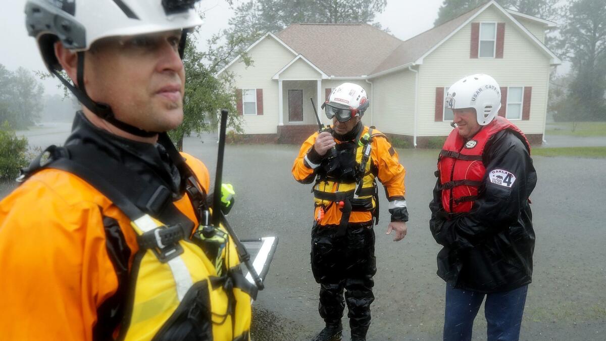Members of the FEMA Urban Search and Rescue Task Force 4 from Oakland search a flooded neighborhood in Fairfield Harbour, N.C., for evacuees on Friday.