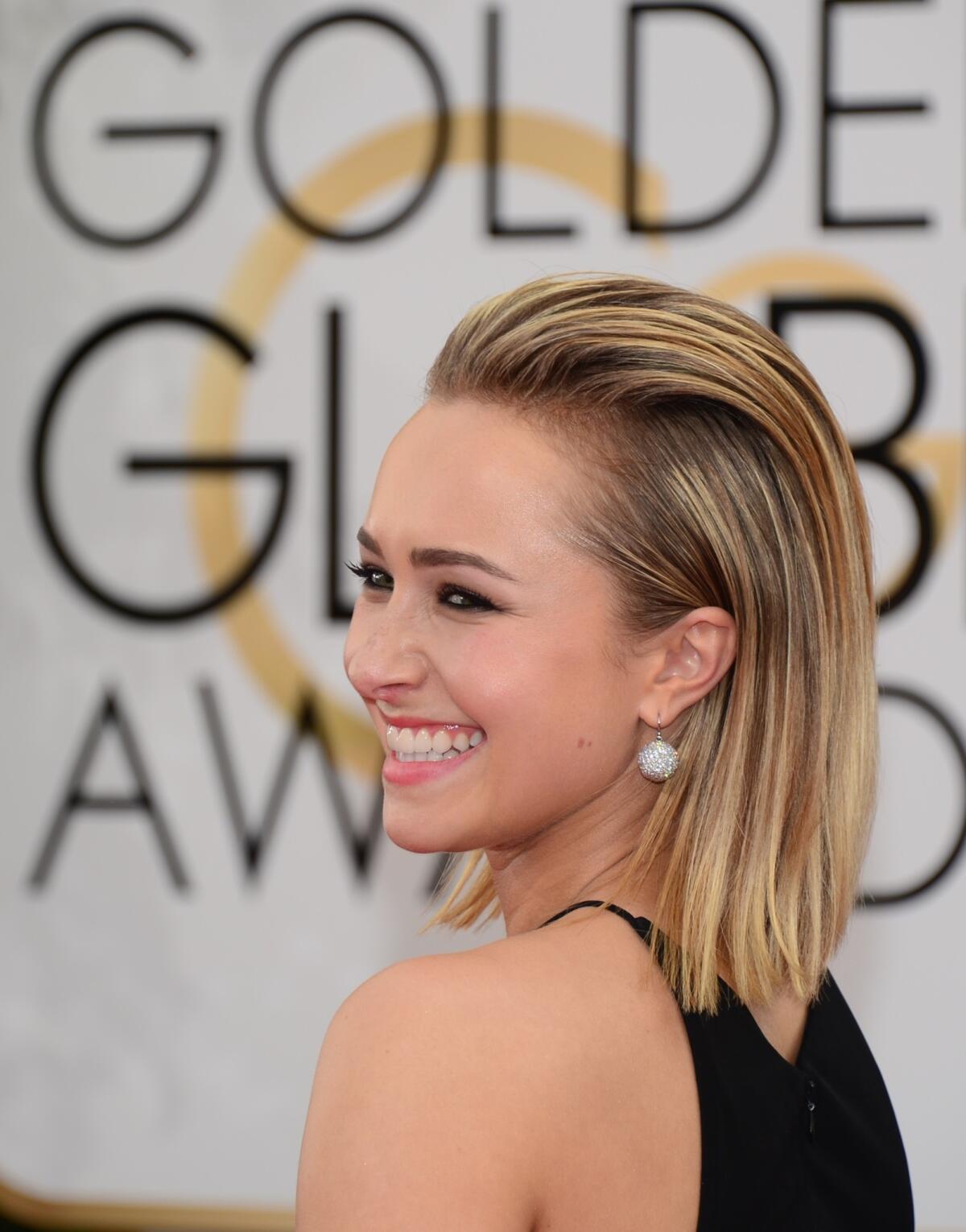 "Nashville" actress Hayden Panettiere wears her hair slicked back for the Golden Globes red carpet.