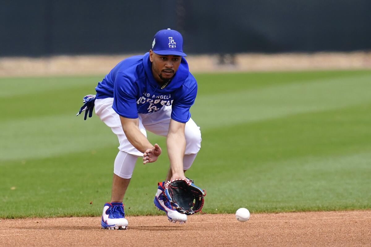 Dodgers' Mookie Betts fields a grounder during a spring training workout.