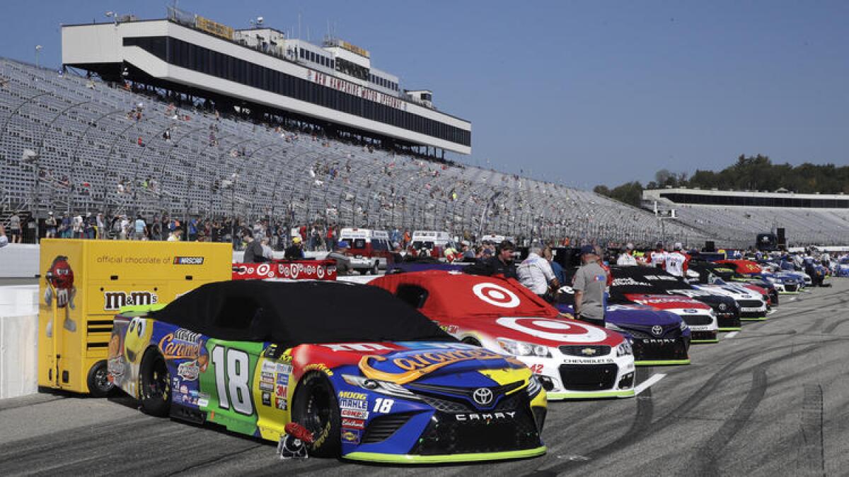 Race cars are lined up prior to the NASCAR Cup Series 300 auto race at New Hampshire Motor Speedway in Loudon, N.H., on Sept. 24.
