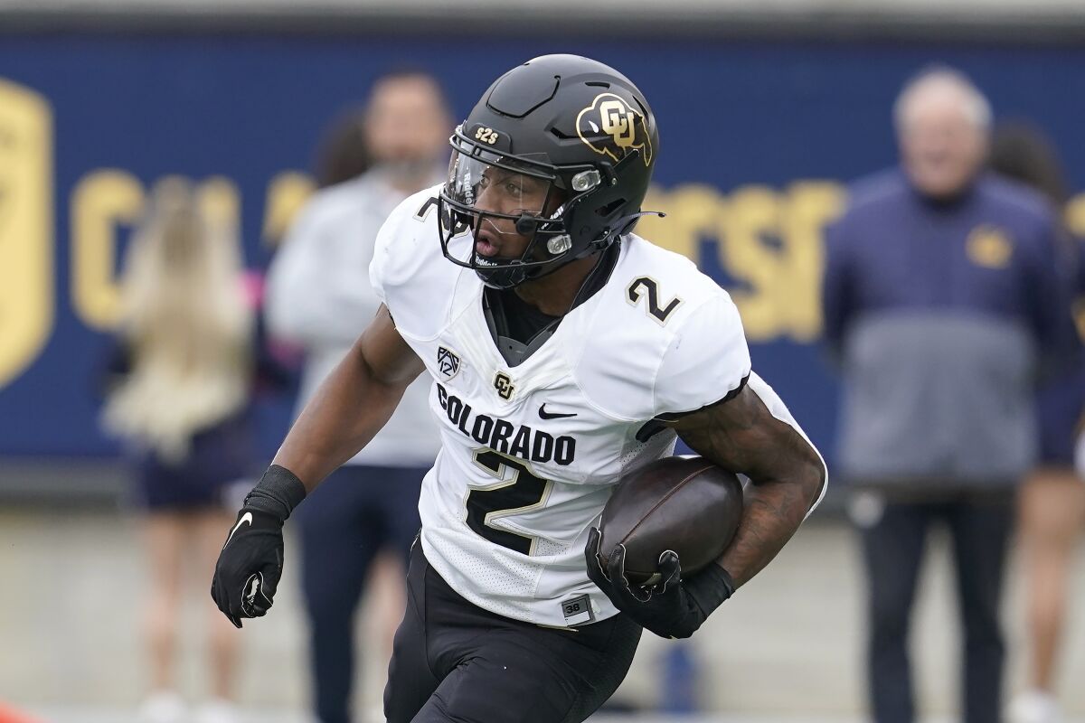 Colorado's Brenden Rice runs with the ball during a game against California.