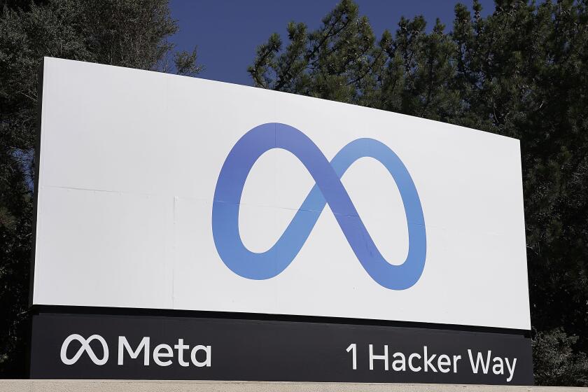 FILE - Facebook's Meta logo sign is seen at the company headquarters in Menlo Park, Calif., Oct. 28, 2021. European Union hits Facebook parent Meta with record $1.3 billion fine over transfers of user data to US. (AP Photo/Tony Avelar, File)