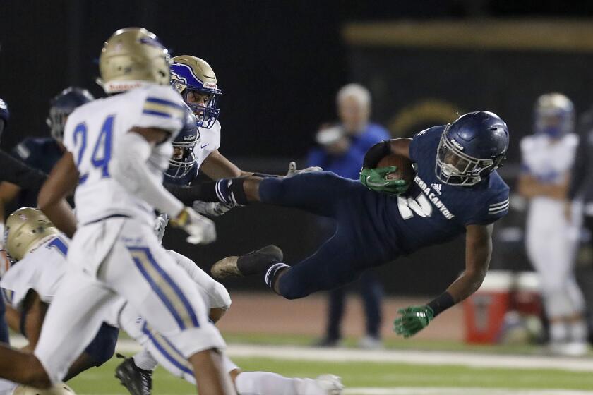 CALABASAS, CALIF. - NOV. 8, 2019. Sierra Canyon's DJ Hasrvey gets airborne after a catch and run against Rancho Santa Margarita during the Division 2 opening playoff game in Calabasas on Friday night, Nov. 8, 2019. (Luis Sinco/Los Angeles Times)