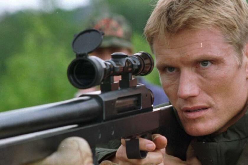 Actor Dolph Lundgren concentrates as he prepares to fire a .50 caliber sniper rifle at the Ethan Allen Firing Range in Underhill, Vt., Thursday, July 20, 1995. Lundgren is filming an action movie in Montreal and came to Vermont so he could live fire the rifle he will use in the movie. (AP Photo/toby talbot)
