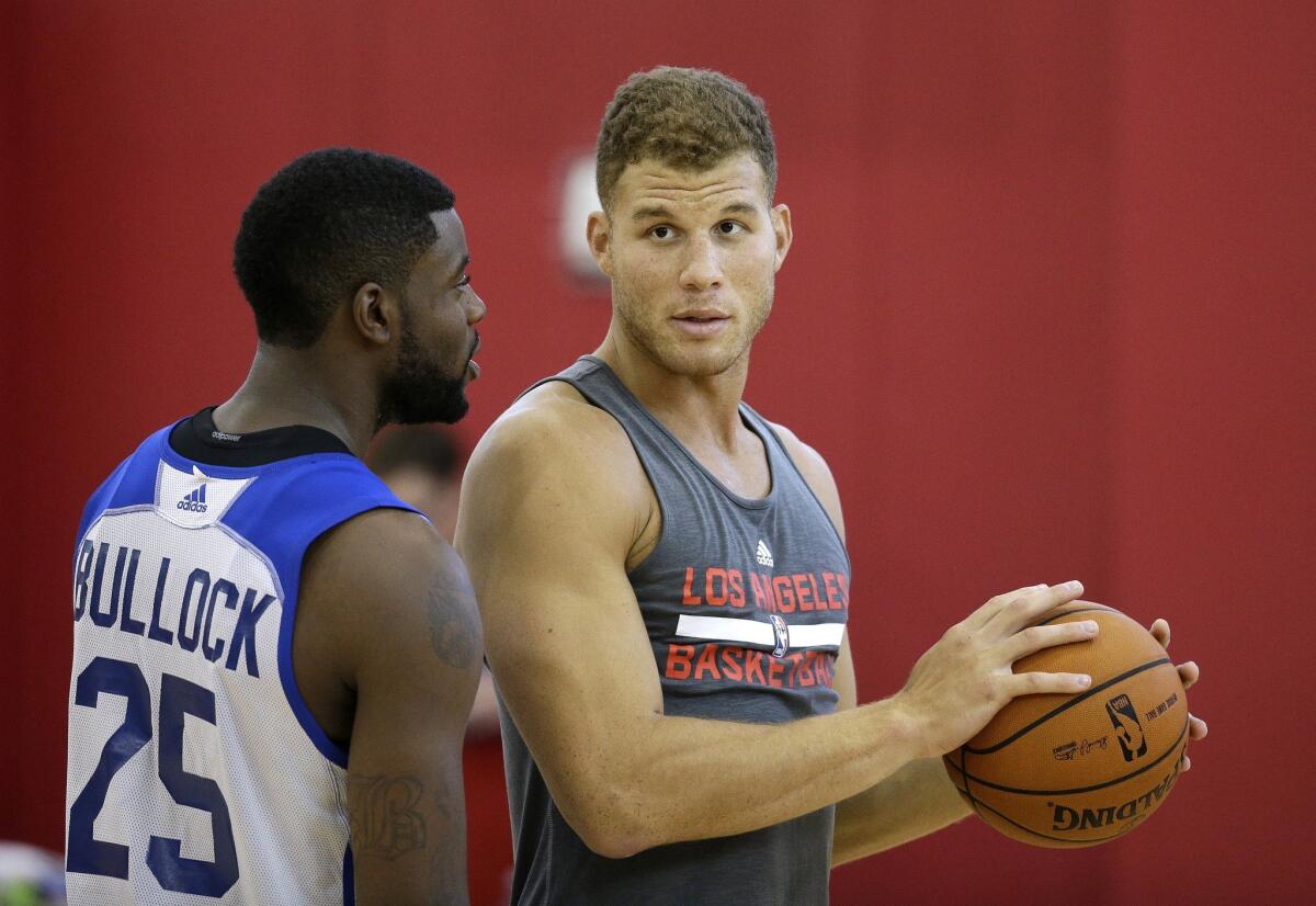 Blake Griffin and Reggie Bullock talk during a training camp practice Thursday in Las Vegas.