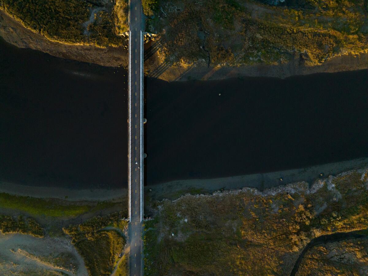 Aerial view of a bridge crossing a river.