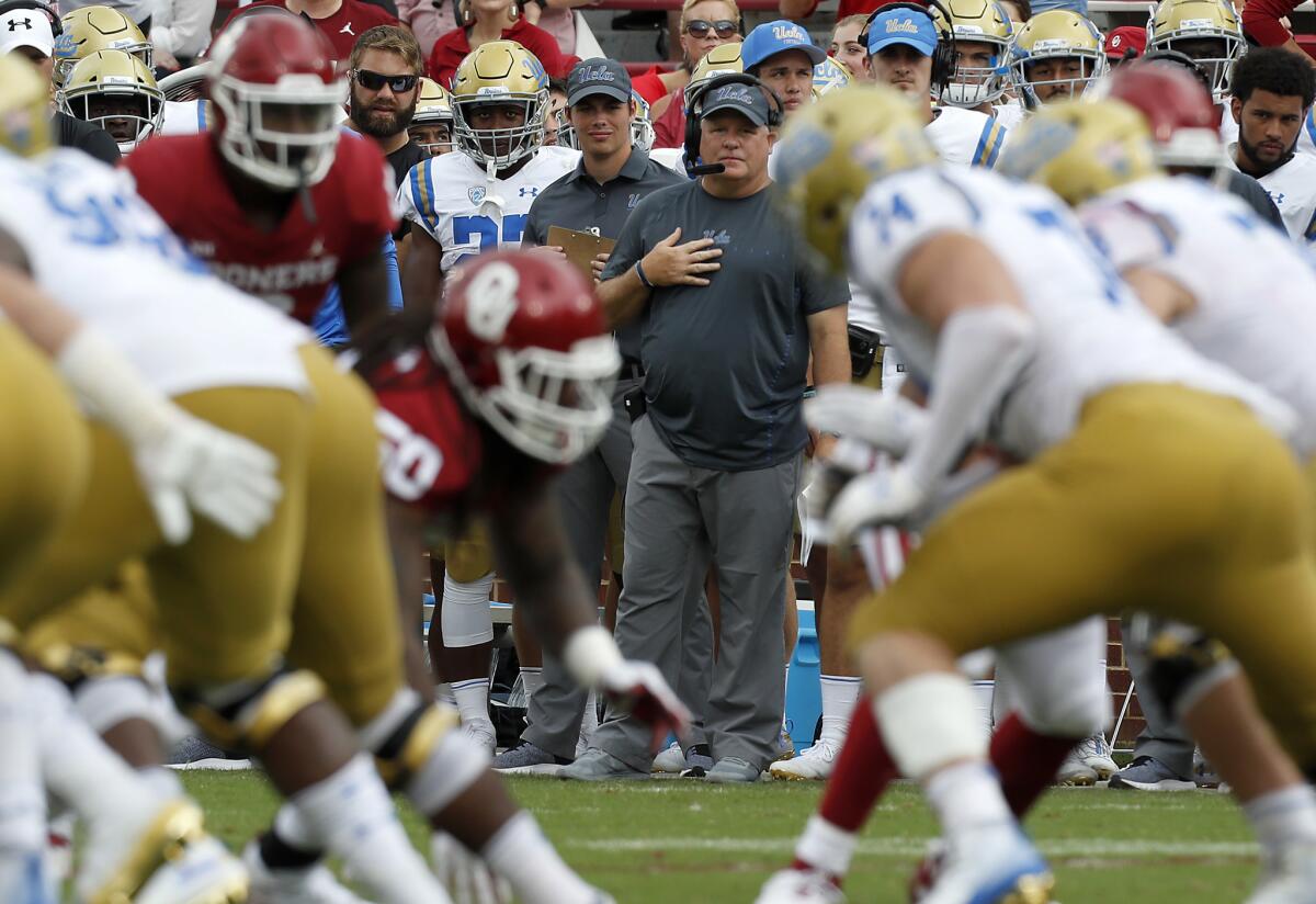 Coach Chip Kelly looks over a UCLA offensive line that continues to struggle.