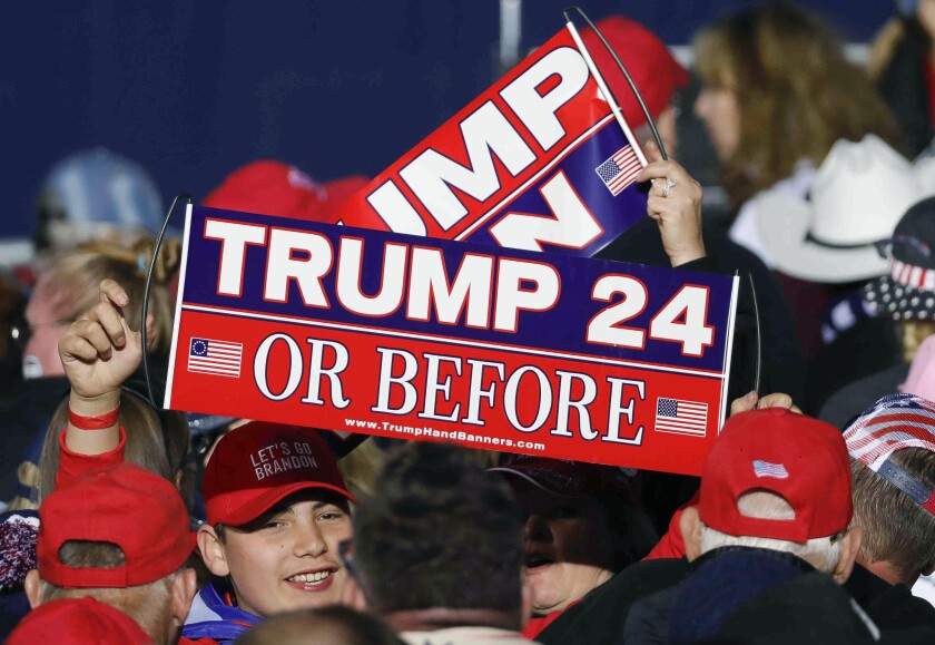 A Trump fan holds up a sign before former President Donald Trump speaks at a rally, Saturday, Jan. 29, 2022, in Conroe, Texas. (Jason Fochtman/Houston Chronicle via AP)