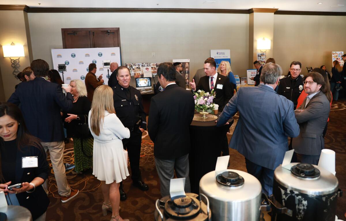 Costa Mesa business leaders and employees network at a chamber-hosted business expo at the Hilton Orange County Wednesday.