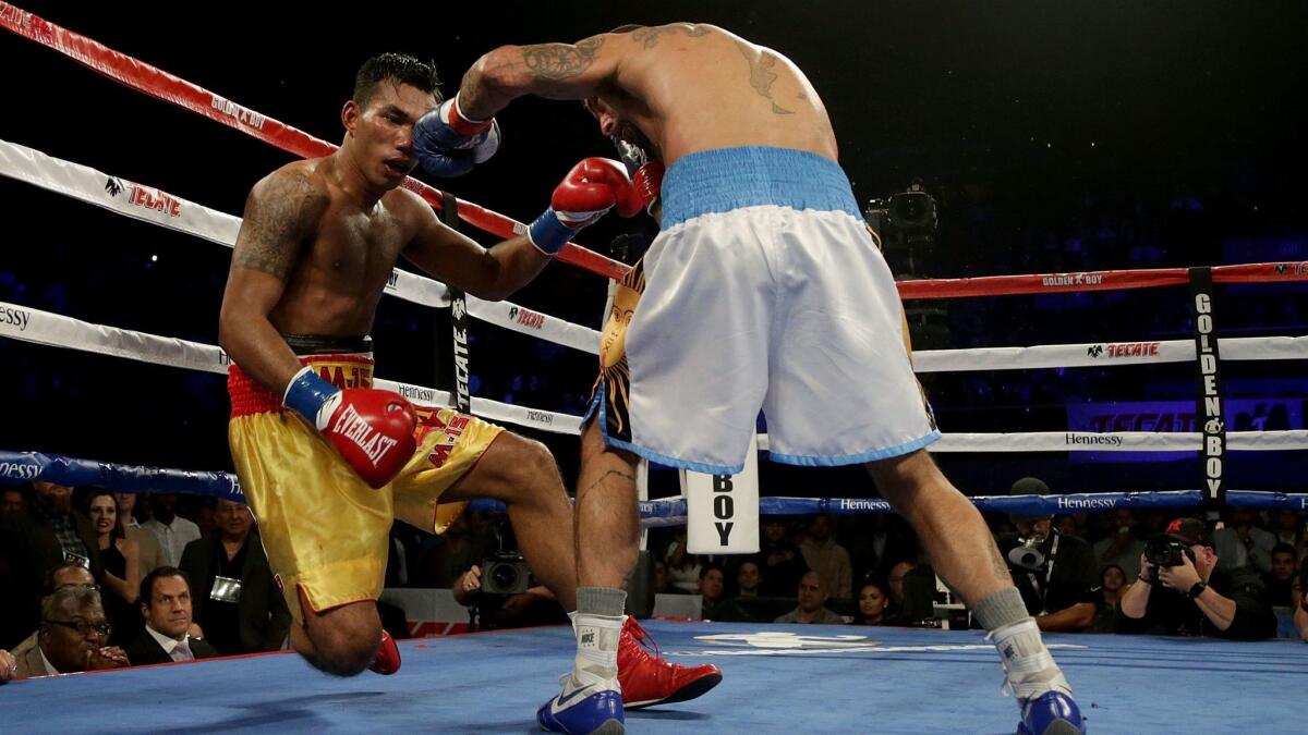 Tewa Kiram of Thailand is knocked out by Lucas Matthysse of Argentina during their bout at The Forum.