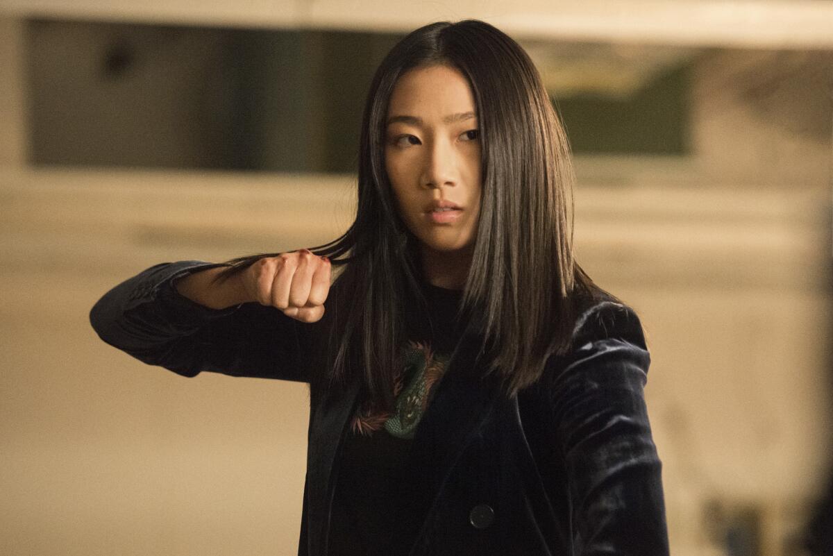 Olivia Liang holds up her clenched fist in "Kung Fu" on the CW