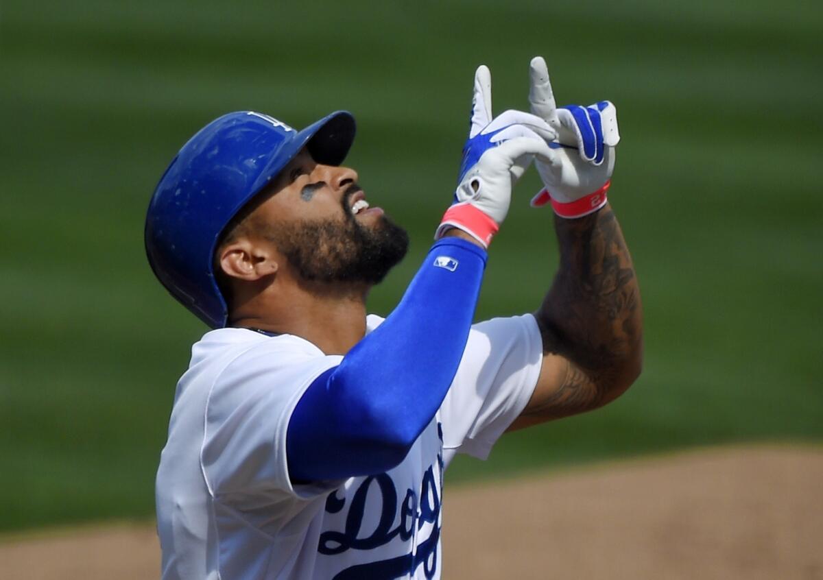 Matt Kemp gestures toward the sky after hitting a solo home run in the first inning of a game Sunday against the Colorado Rockies.