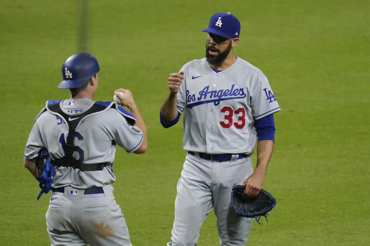 Dodgers pitcher David Price celebrates with catcher Will Smith after defeating the San Diego Padres.