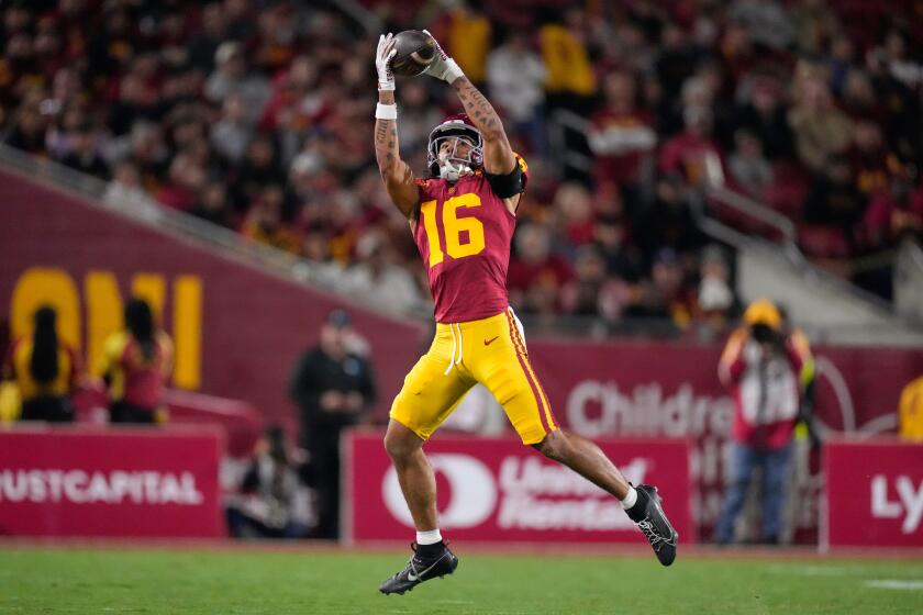 Southern California wide receiver Tanook Hines catches a pass thrown by third-string quarterback Sam Huard on a fake punt in the first half of an NCAA college football game against Northwestern, Friday, Nov. 7, 2025, in Los Angeles. (AP Photo/Mark J. Terrill).