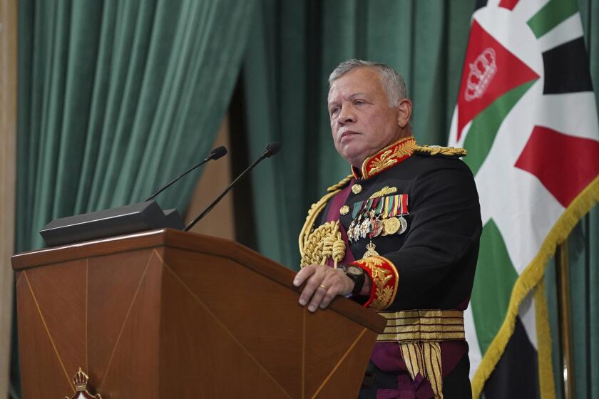 FILE - In this Dec. 10, 2020 file photo released by the Royal Hashemite Court, Jordan's King Abdullah II gives a speech to parliament, in Amman Jordan. Jordan's version of a trial of the century gets under way as early as Monday, June 21, 2021. A relative of King Abdullah II and a former chief of the royal court will be ushered into the defendants’ cage at the state security court to face sedition charges. They are accused of conspiring with Prince Hamzah, a half-brother of the king, to foment unrest against the monarch. (Yousef Allan/The Royal Hashemite Court via AP, File)