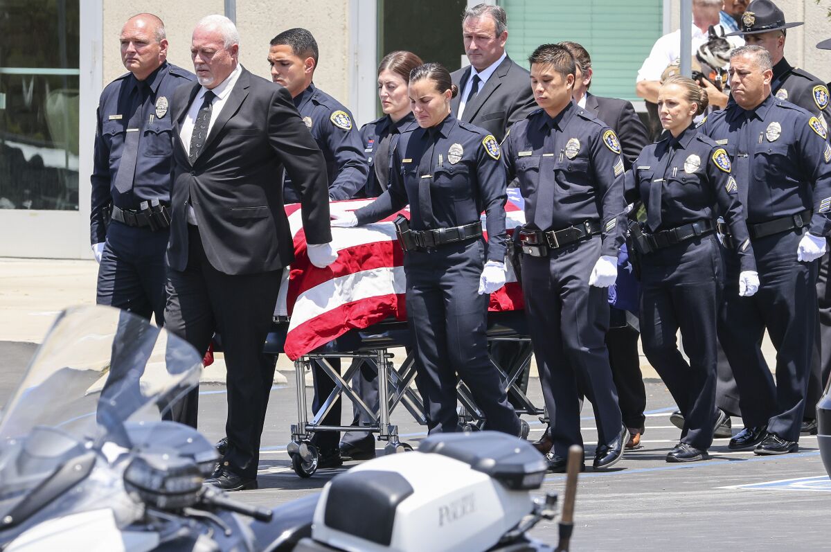 Pallbearers carry the casket of San Diego police Detectives Jamie Huntley-Park and Ryan Park after their memorial service.