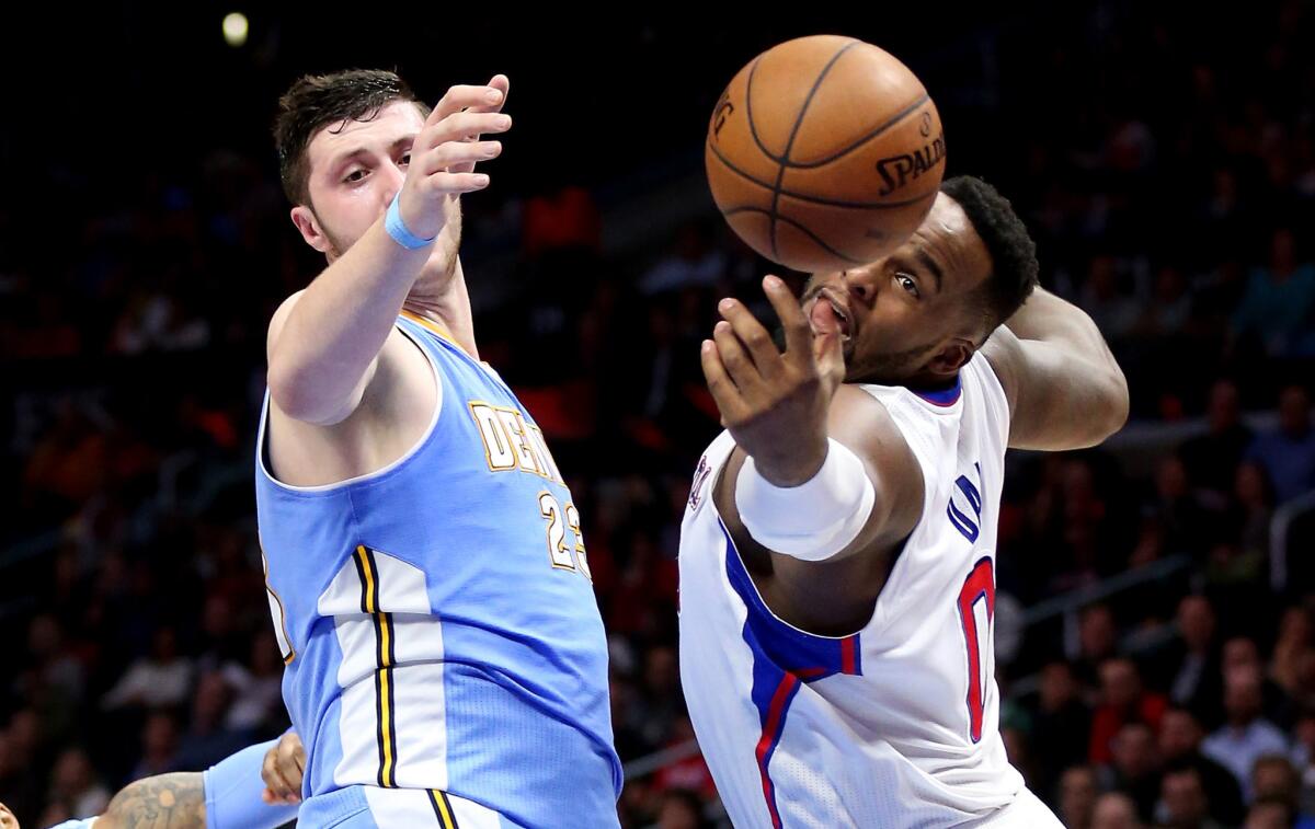 Nuggets center Jusuf Nurkic and Clippers power forward Glen Davis both reach for a loose ball in the second half of the Clippers' 102-98 victory Monday night.