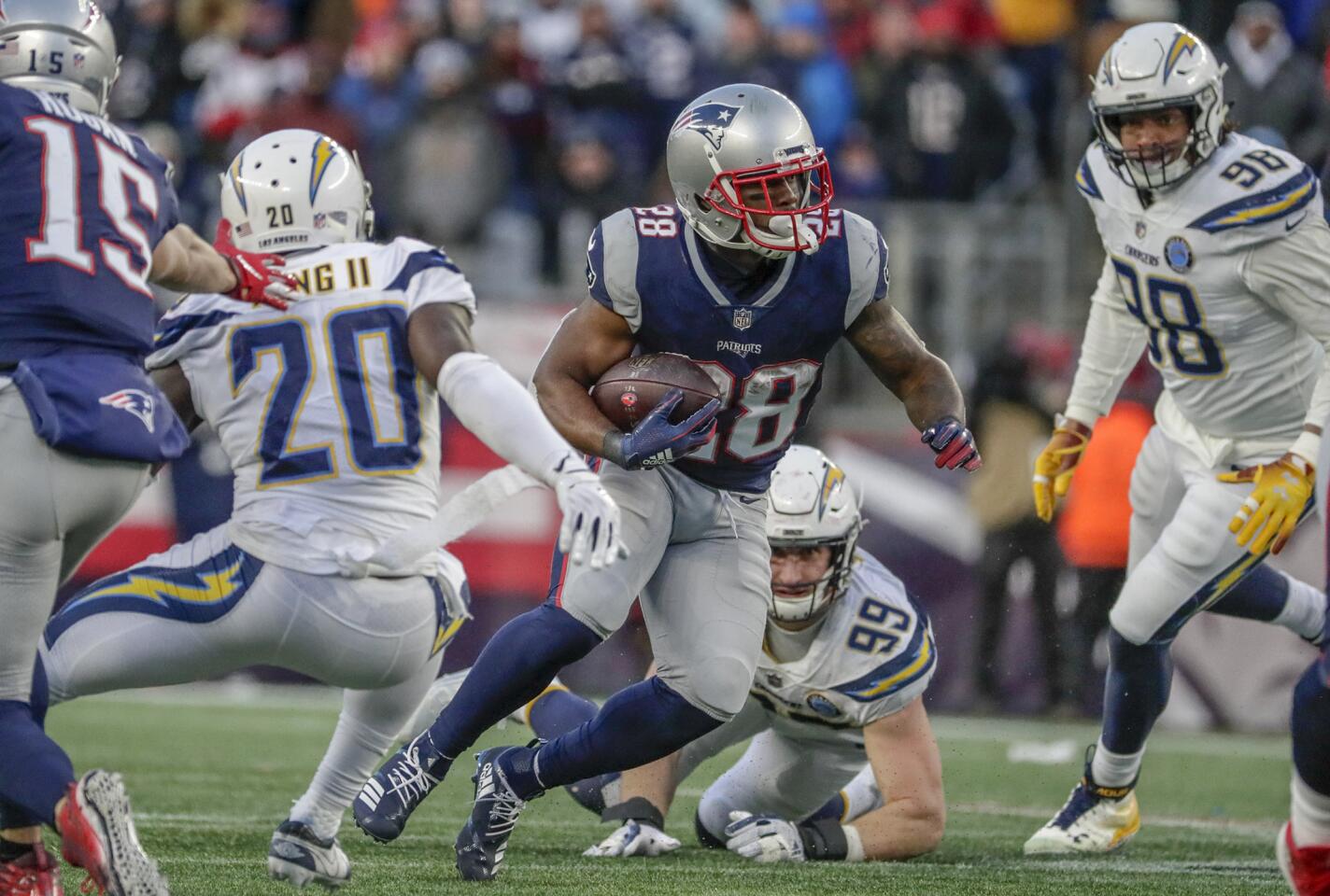 New England Patriots running back James White heads upfield on a screen pass late in the game against the Chargers in the NFL AFC Divisional Playoff at Gillette Stadium on Sunday.