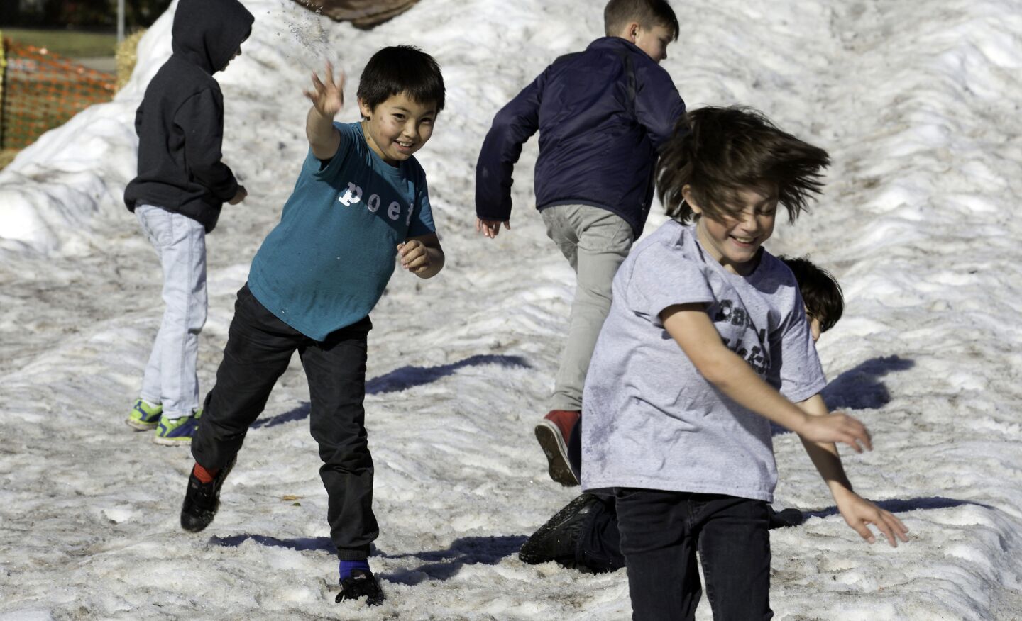 Elementary schoolchildren play on a snow hill at the Studio City Recreation Center in Studio City. All were from area public and private schools that were closed Tuesday.