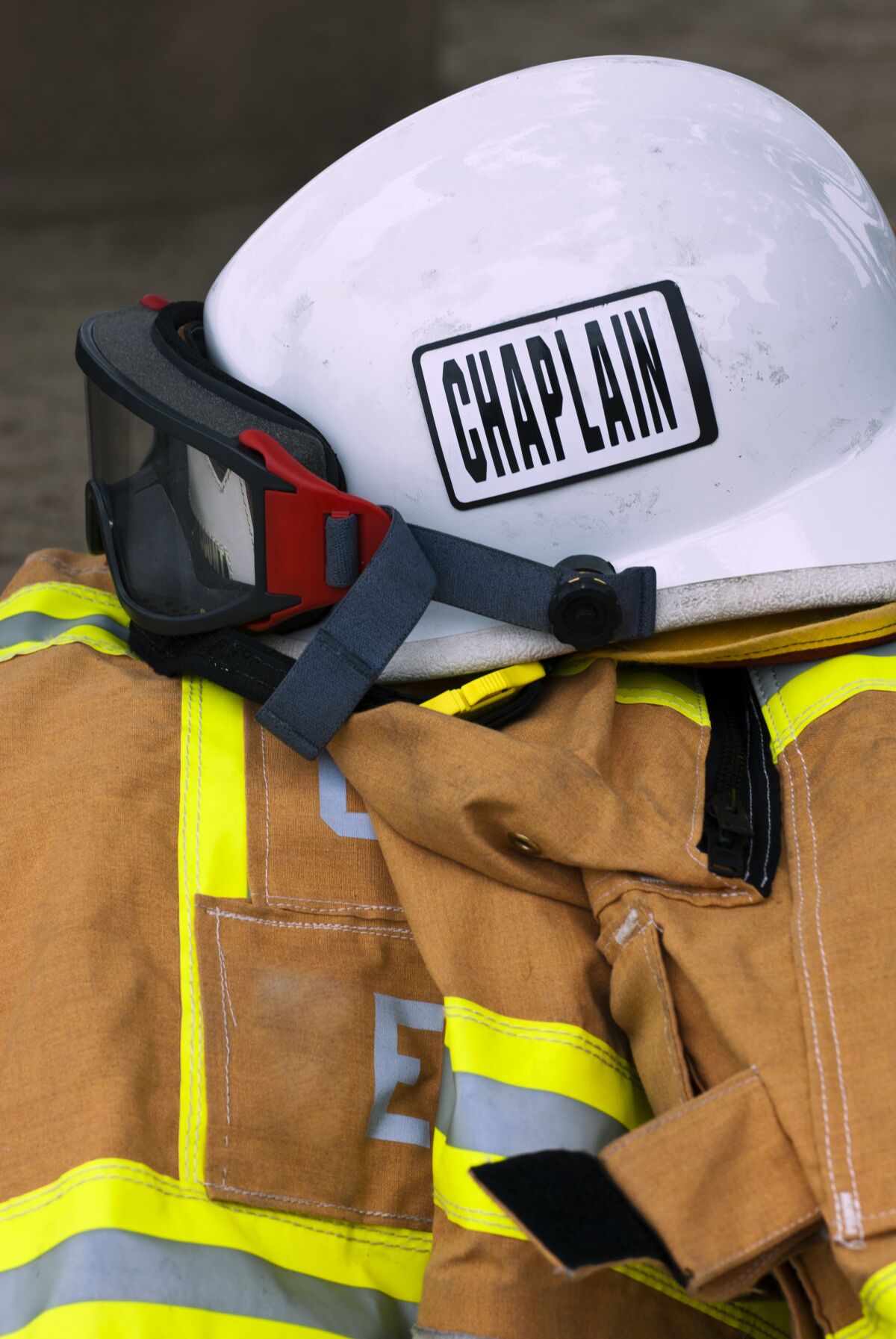 Chaplain's helmet and turnout gear from fire department