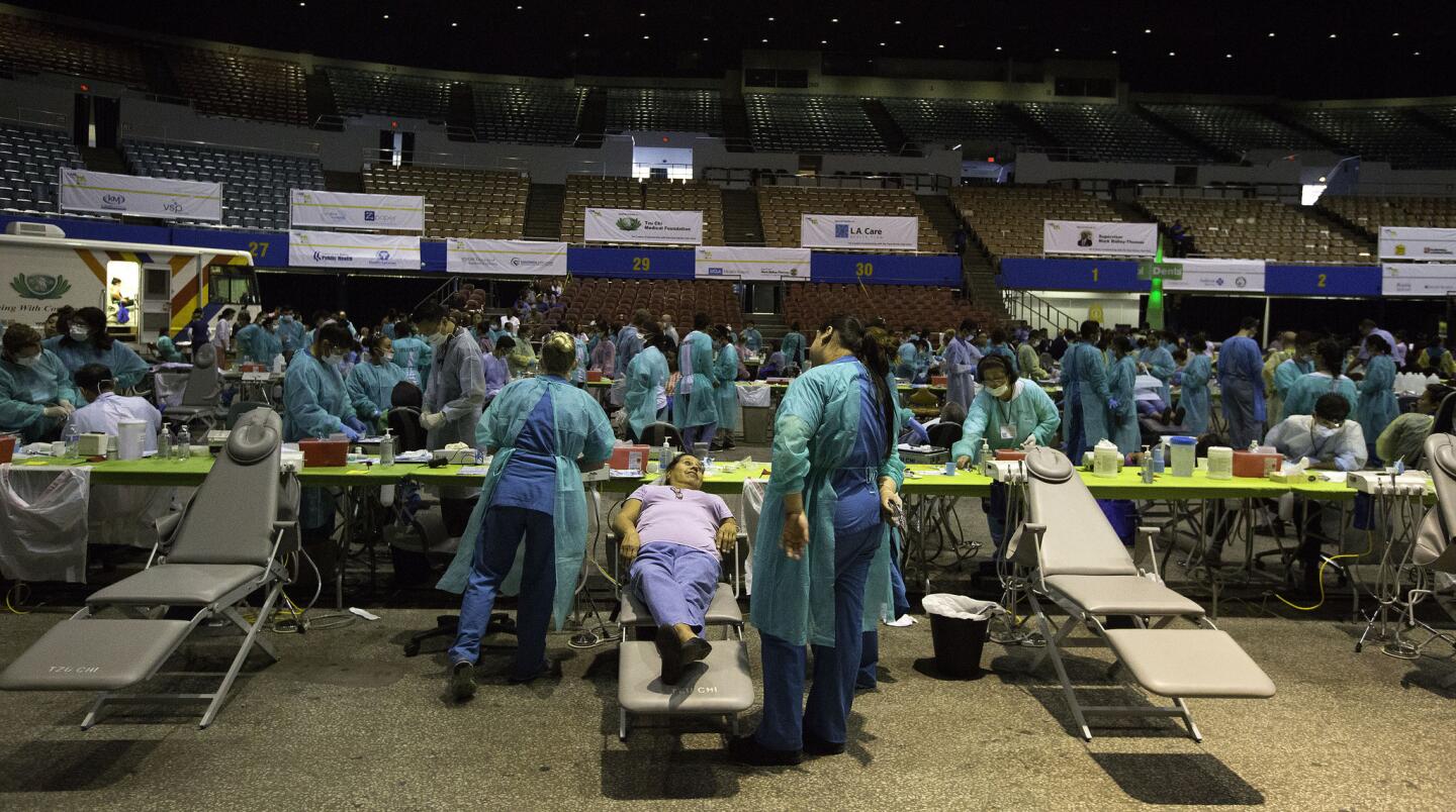 Thousands of volunteers assemble for Care Harbor's four-day health clinic at the Los Angeles Memorial Sports Arena.