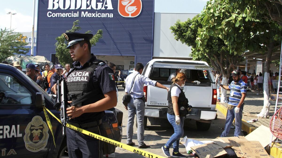 Police and forensics secure an area Jan. 4 in Acapulco, after attackers reportedly got out of a vehicle and began shooting, killing six street vendors.