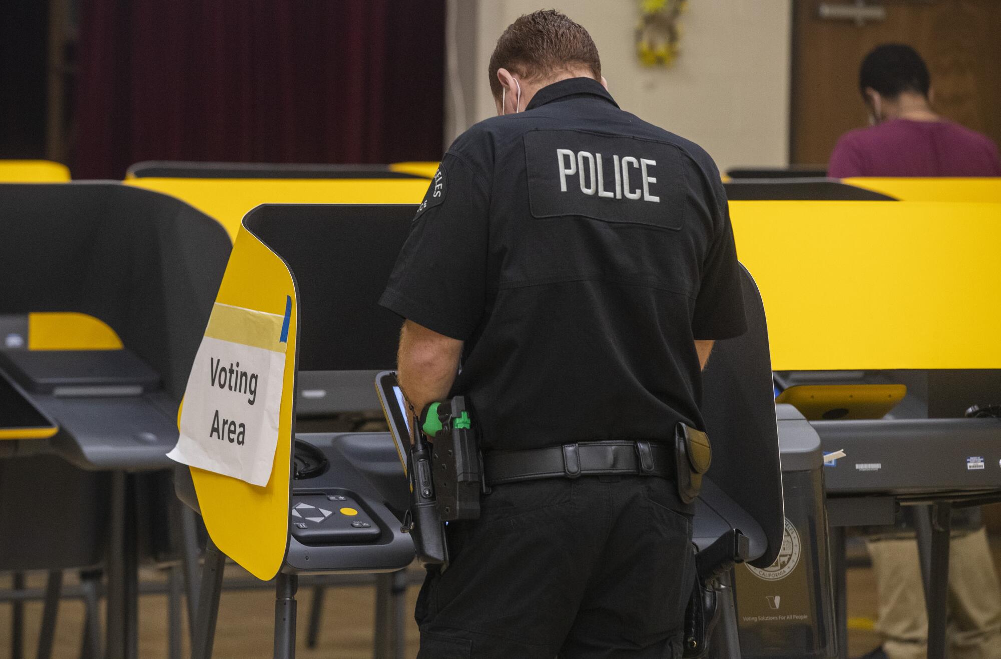 An LAPD officer casts his ballot