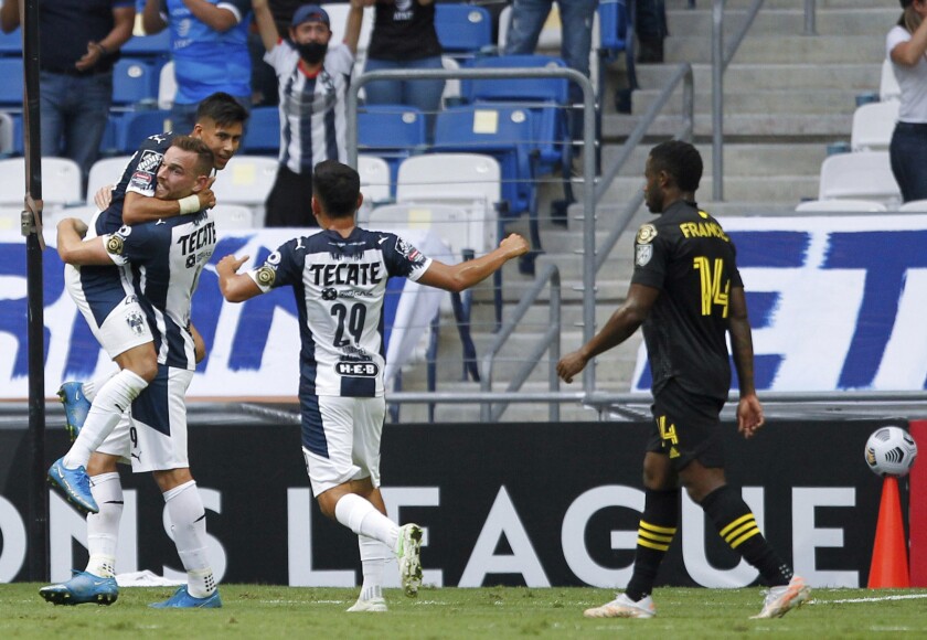 Maximiliano Meza of Mexico's Monterrey, left, is congratulated by his teammates after scoring his team's second goal against Unites States' Columbus Crew in a Concacaf Champions League soccer game in Monterrey, Mexico, Wednesday, May 5, 2021. (AP Photo/Roberto Martinez)
