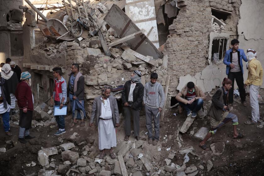 FILE - People gather at the site of a Saudi-led airstrike near Yemen's Defense Ministry complex in Sanaa, Yemen, Saturday, Nov. 11, 2017. The world must not lose sight of the plight of those living through the yearslong war in Yemen, Katharina Ritz, the International Committee of the Red Cross’ head of delegation in Yemen said Friday, March 11, 2022, urging continued aid for the Middle East's poorest nation as the war in Ukraine grabs the world's attention. (AP Photo/Hani Mohammed)