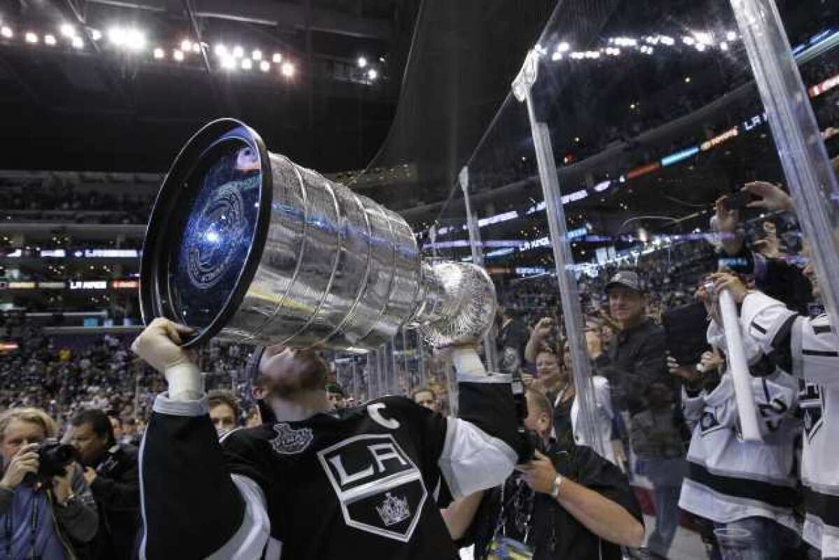 Dustin Brown gives fans at Game 6 of the Stanley Cup Final a closer look at the trophy.