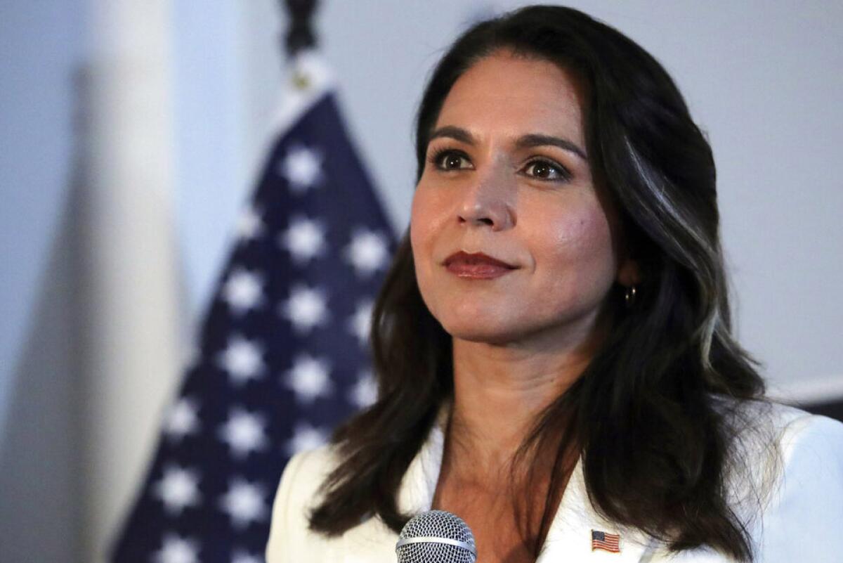 Rep. Tulsi Gabbard of Hawaii, pictured Oct. 1 during a campaign stop in New Hampshire, has gotten renewed attention lately after a heated argument with former Democratic presidential nominee Hillary Clinton.