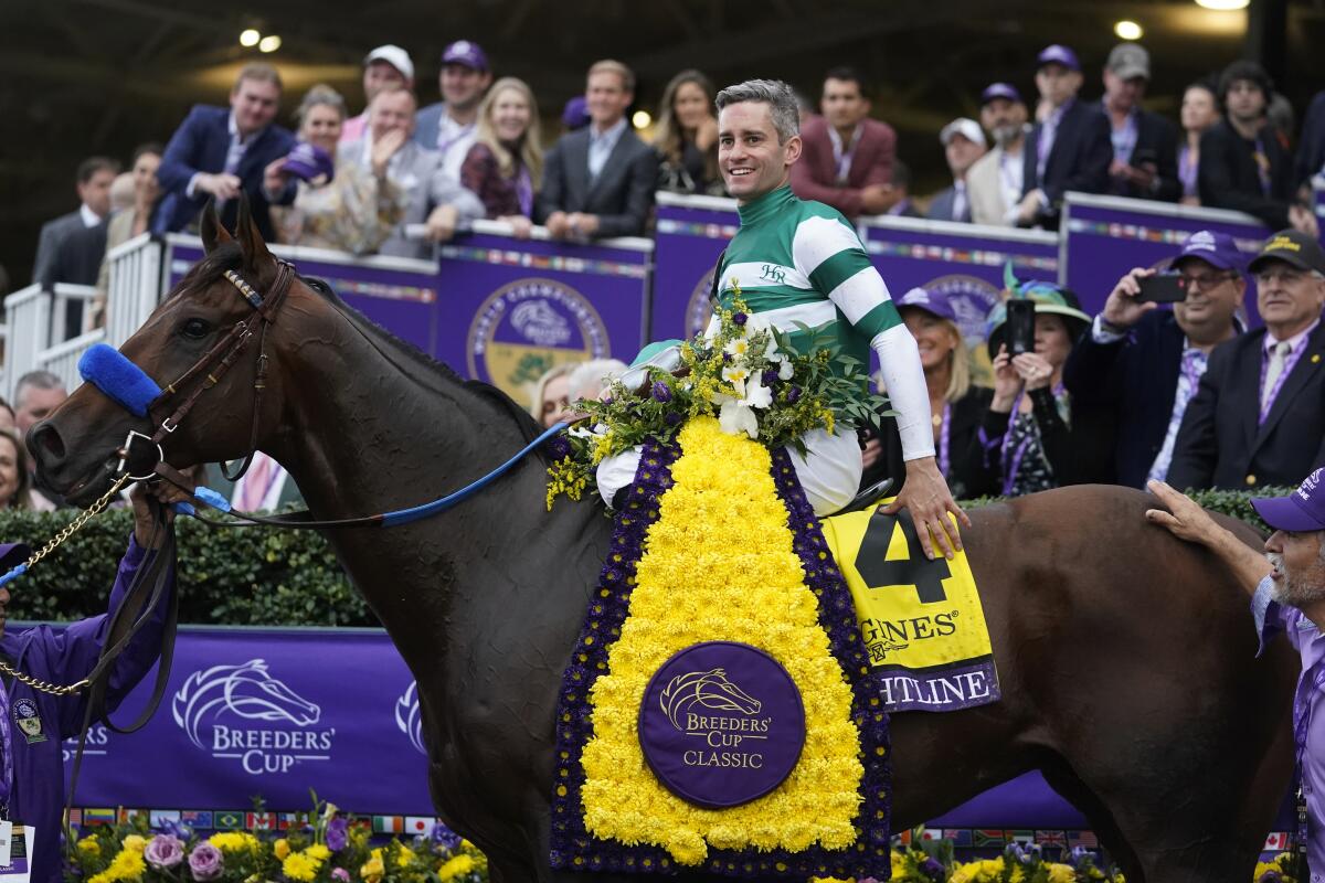 Flavien Prat poses in the Winner's Circle after riding Flightline to victory during the Breeders' Cup Classic race.