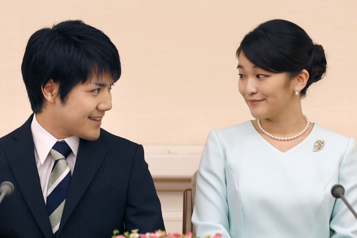 FILE - In this Sept. 3, 2017, file photo, Japan's Princess Mako and her fiance Kei Komuro look at each other during a press conference at Akasaka East Residence in Tokyo. Mako and Komuro are getting married next month but no wedding ceremonies are planned because their marriage is not fully supported by the pubic because of a financial dispute involving her future mother-in-law, the palace announced Friday, Oct. 1, 2021. (AP Photo/Shizuo Kambayashi, Pool, File)