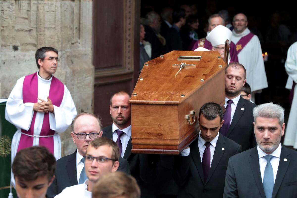 Pallbearers carry the coffin of Father Jacques Hamel as they leave Rouen cathedral on Aug. 2 at the end of the funeral of the 85-year-old priest killed by jihadists last week.
