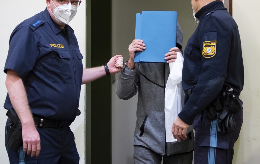 FILE - A man accused of murder by omission arrives in the courtroom before his trial begins, in Munich, Germany. Thursday, Oct. 28, 2021. A German court has convicted the 67-year-old electrician of aggravated, dangerous and simple assault for removing the testicles of several men at their request, causing one person to die, the dpa news agency reported. (Sven Hoppe/dpa via AP, File)