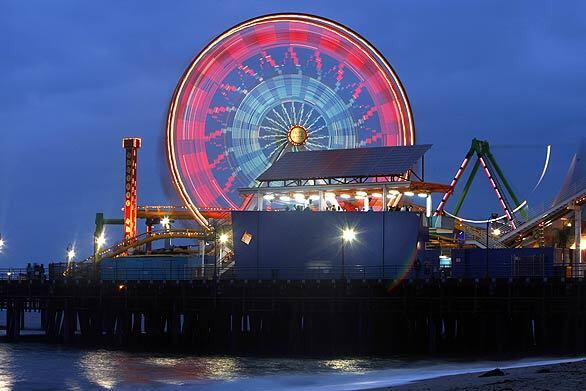 The sun sets on the Ferris wheel at the Santa Monica Pier. The attraction, which has provided millions of rides since 1996, has been sold on EBay and will be disassembled and shipped to its new owner in Oklahoma.