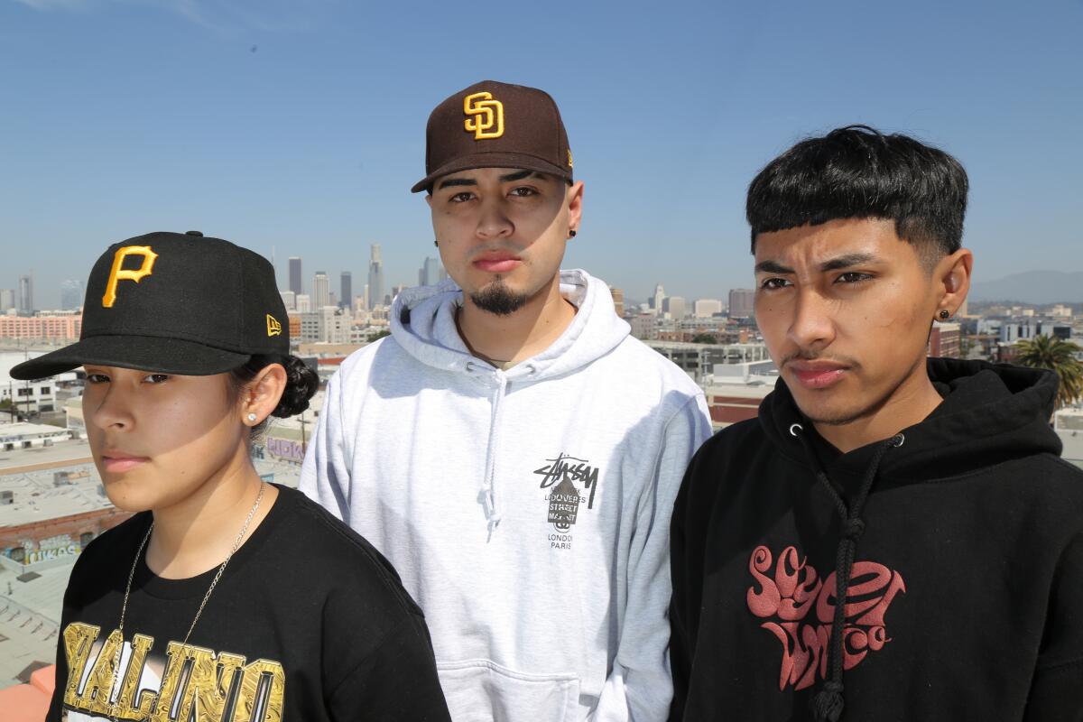 Three young members of a Latin music group.