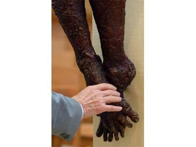 A worshiper touches the foot of a statue of Jesus Christ in the new $189.5-million cathedral.