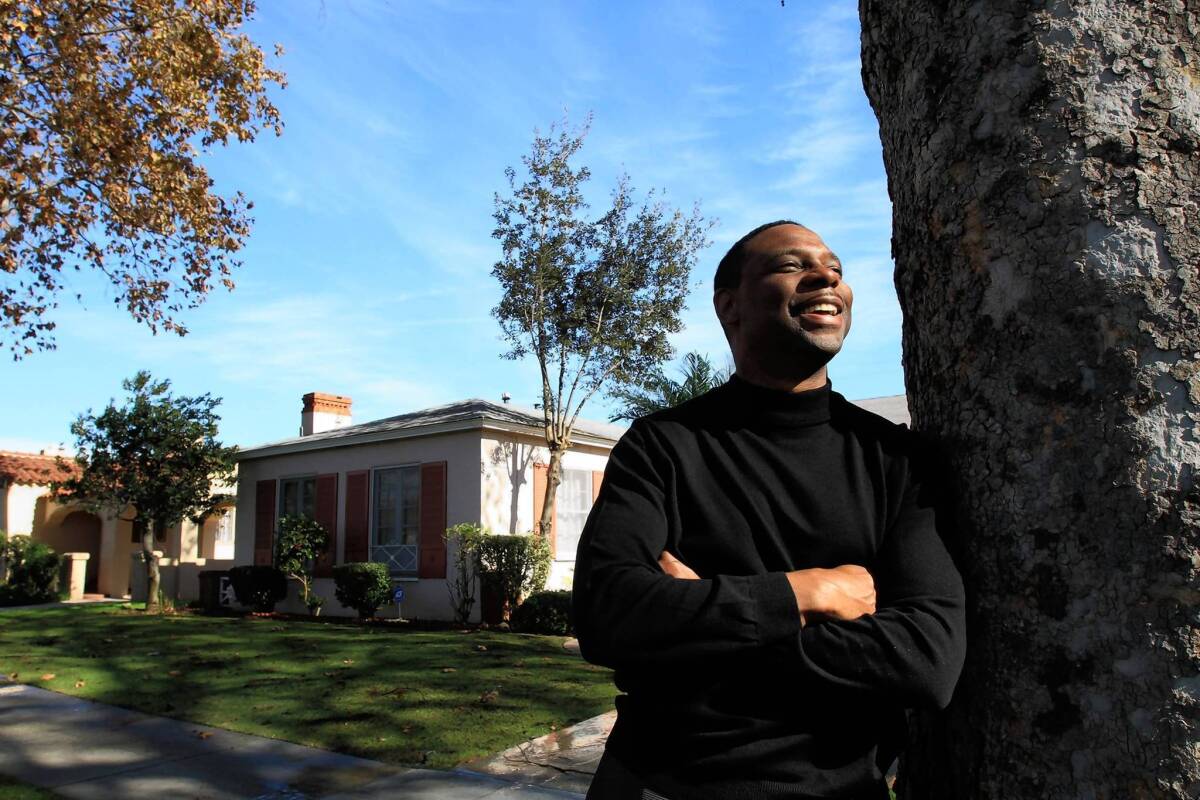 Tony Tolbert, of UCLA School of Law, is shown outside of the home he has been letting families live in rent free. He moved into a duplex with his mother to make it happen.