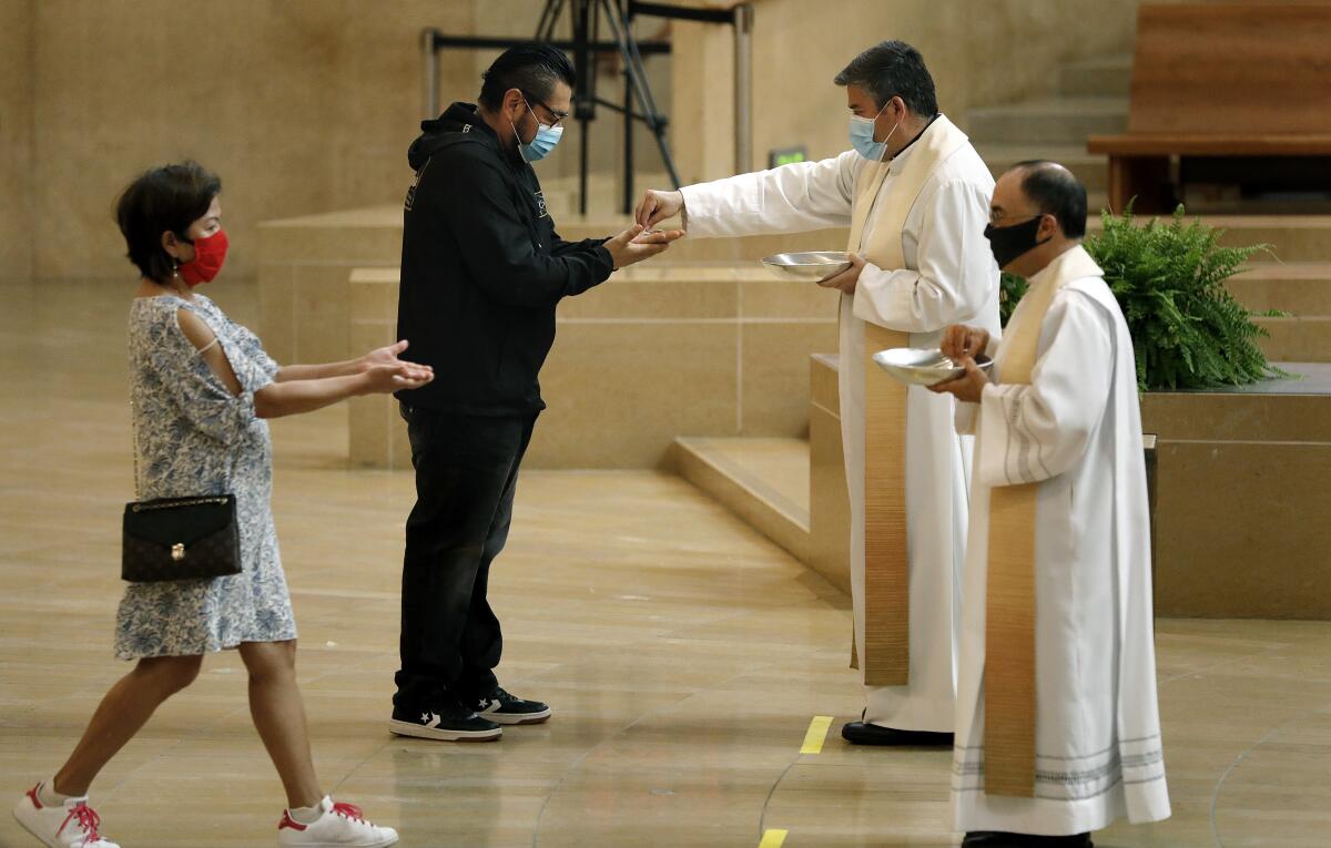 Worshipers are welcomed back at the Cathedral of Our Lady of the Angels in downtown Los Angeles on Sunday, June 7, 2020