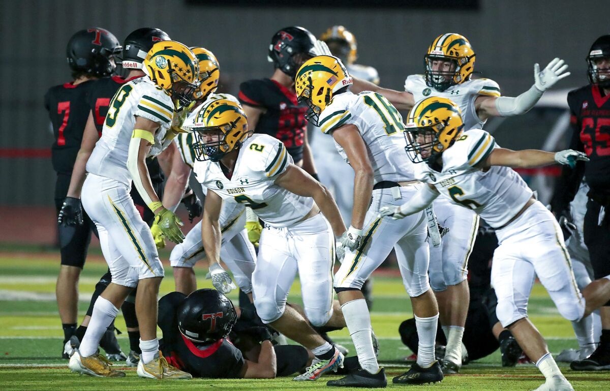 A host of Edison defenders rise rise up after stopping a crucial fourth-and-inches play during the Chargers' win Friday.