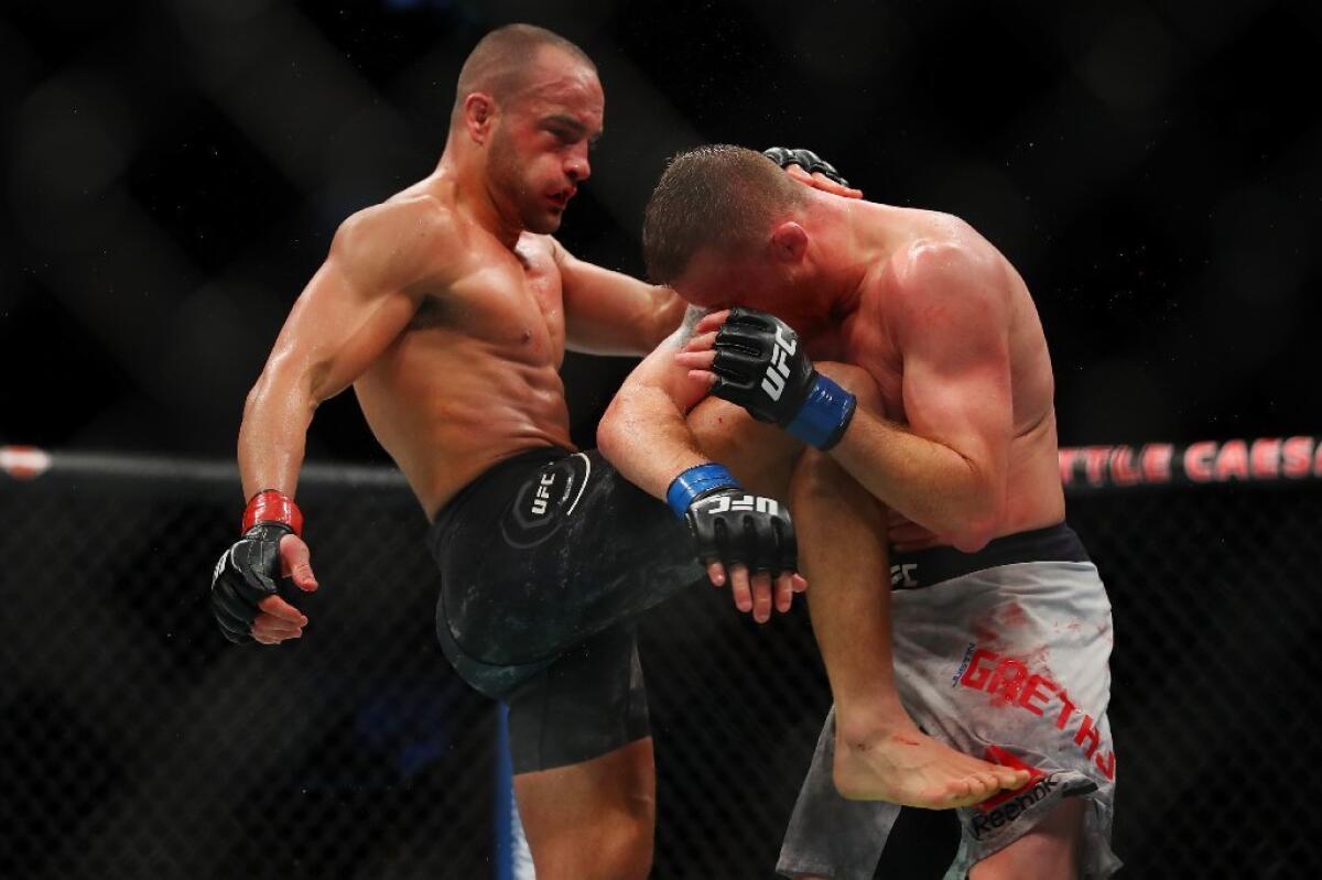 Eddie Alvarez hits Justin Gaethje with a knee during their fight at UFC 218.