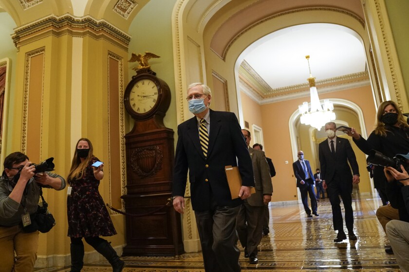 Senate Minority Leader Mitch McConnell heads back to his office after calling the Senate into session on Jan. 25. 