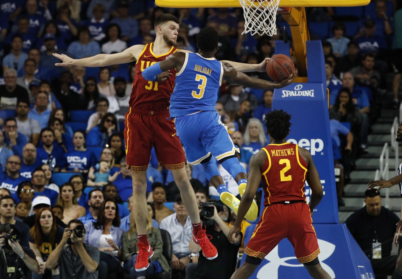 USC forward Nick Rakocevic (31) goes for the bock on UCLA guard Aaron Holiday (3) in the second half at Pauley Pavilion on Saturday.