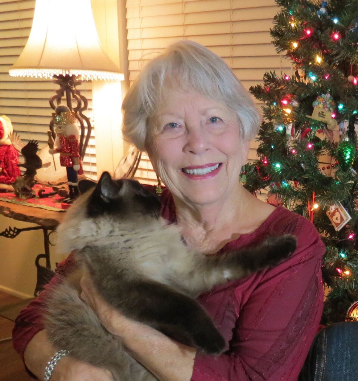 Wanda McLaughlin poses with on of her two cats.