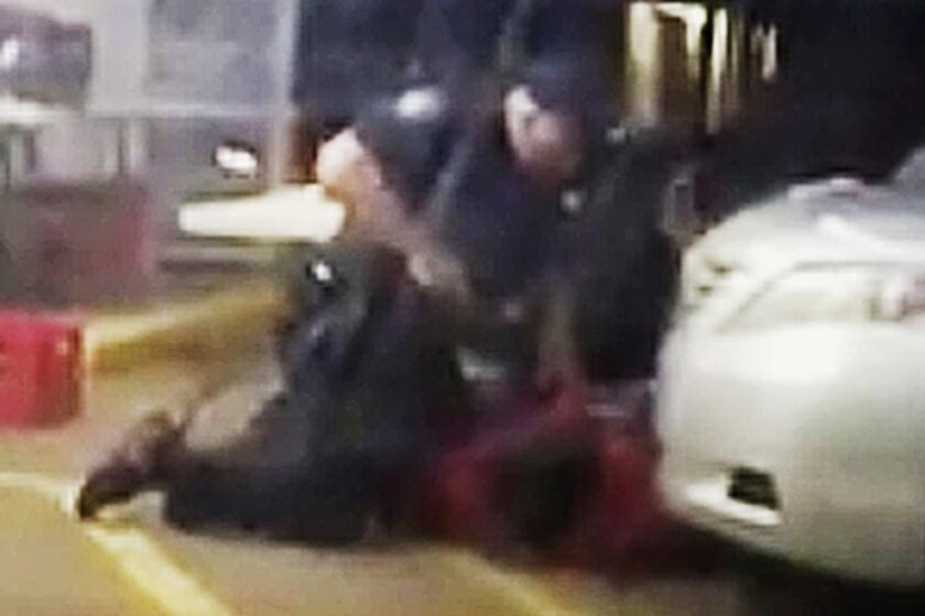 FILE - In this July 5, 2016 image made from video provided by Arthur Reed, Alton Sterling is restrained by two Baton Rouge police officers, one holding a gun, outside a convenience store in Baton Rouge, La. Moments later, one of the officers shot and killed Sterling, a black man who had been selling CDs outside the store, while he was on the ground. The investigation of the deadly police shooting that inflamed racial tensions in Louisianaâs capital city has ended without criminal charges against two white officers who confronted Sterling. . Experts in police tactics think the bloodshed could have been avoided if the Baton Rouge officers had done more to defuse the encounter with Sterling. .(Arthur Reed via AP, File