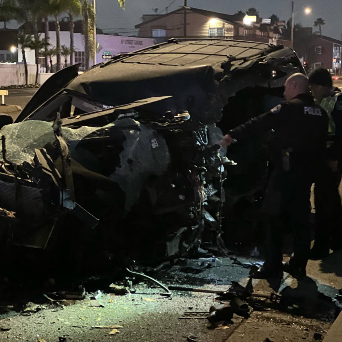 Two individuals were pinned inside a vehicle that crashed into a tree on PCH near Seal Beach Boulevard early Sunday.